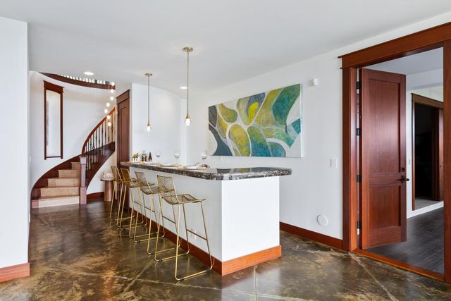 a living room with table and stairs