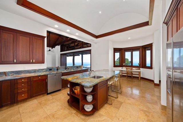 a dining hall with stainless steel appliances granite countertop a stove and a sink