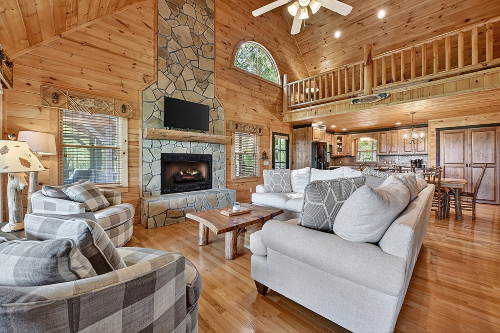 296 Overlook Road Blue Ridge, GA 30513 - Photo 33 of 65 a living room with furniture a fireplace and a large window