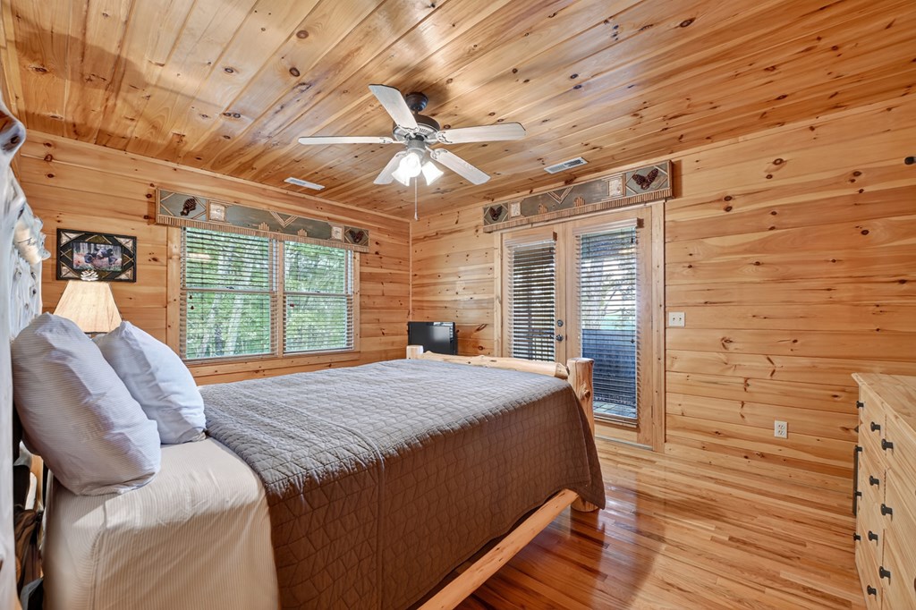 296 Overlook Road Blue Ridge, GA 30513 - Photo 54 of 65 a bed sitting in a spacious bedroom next to a window