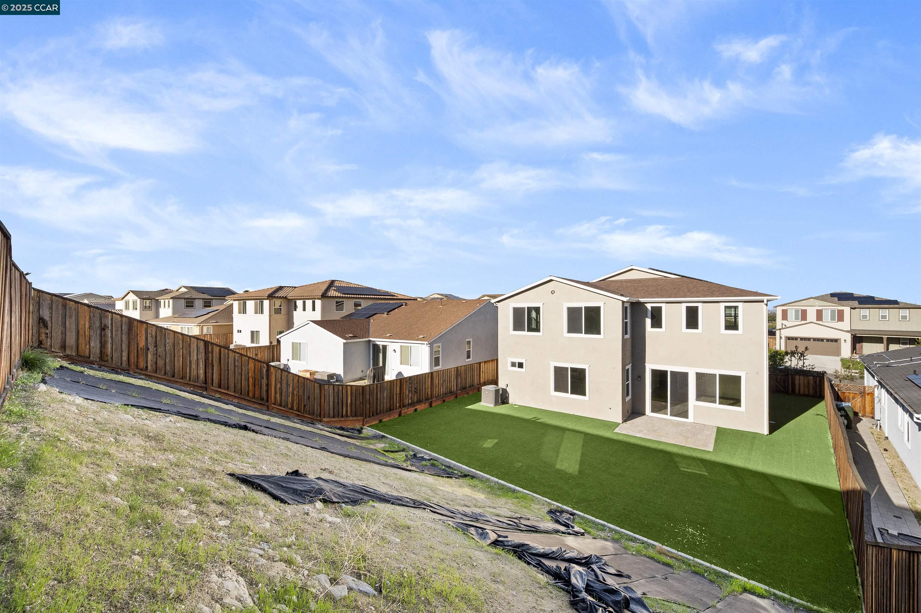 5541 Promontory Way Antioch, CA 94531 - Photo 12 of 59 a view of a white house next to a yard with big trees