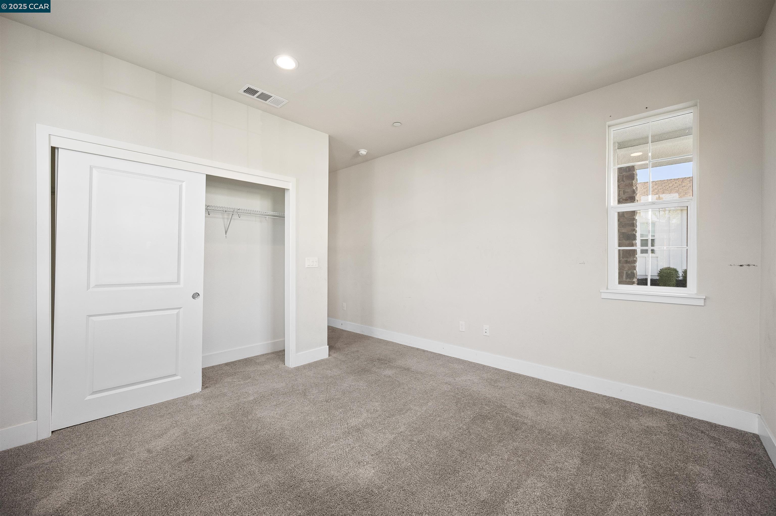 5541 Promontory Way Antioch, CA 94531 - Photo 35 of 59 an empty room with windows and closet