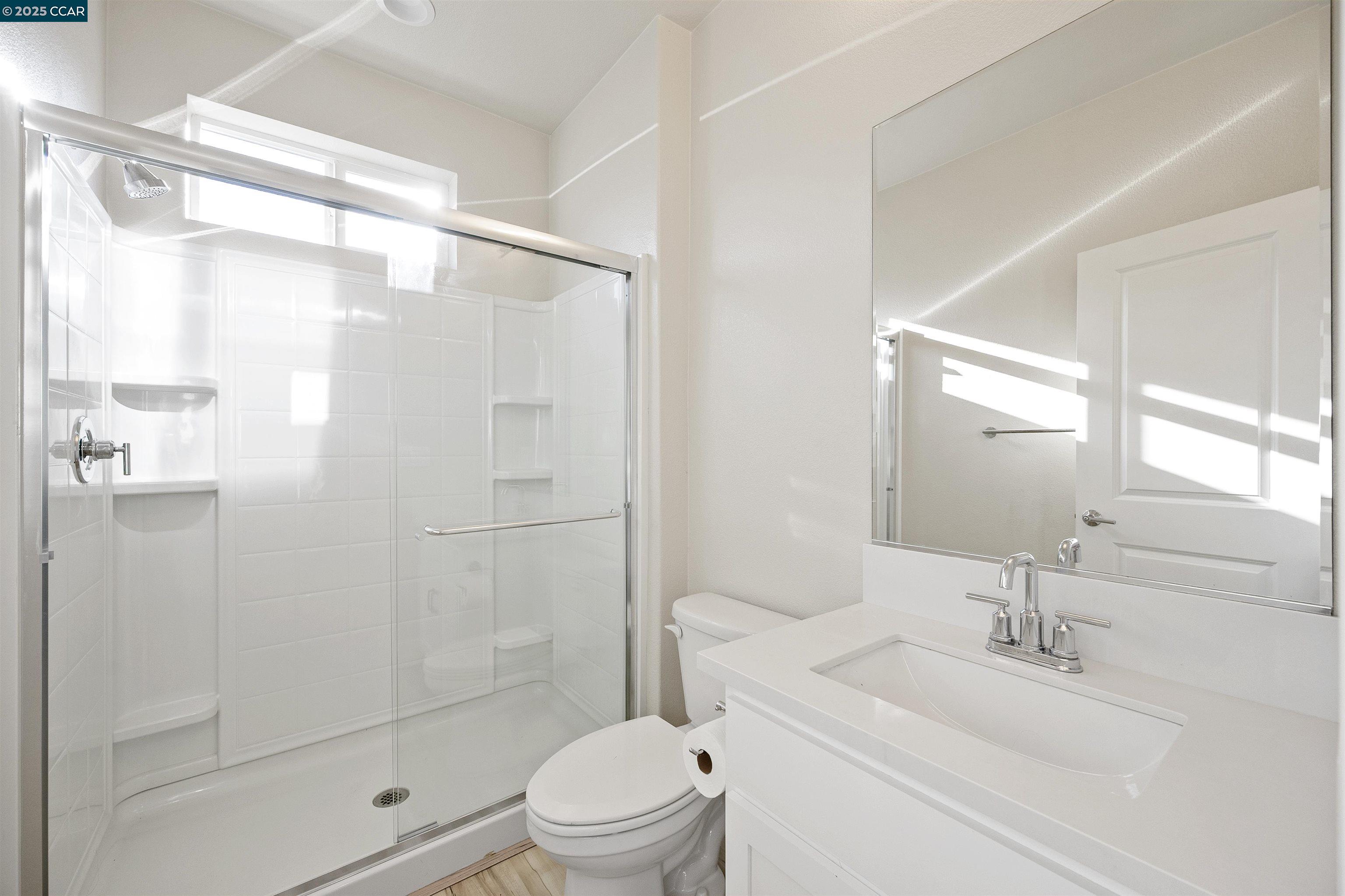 5541 Promontory Way Antioch, CA 94531 - Photo 40 of 59 a bathroom with a sink a toilet and shower