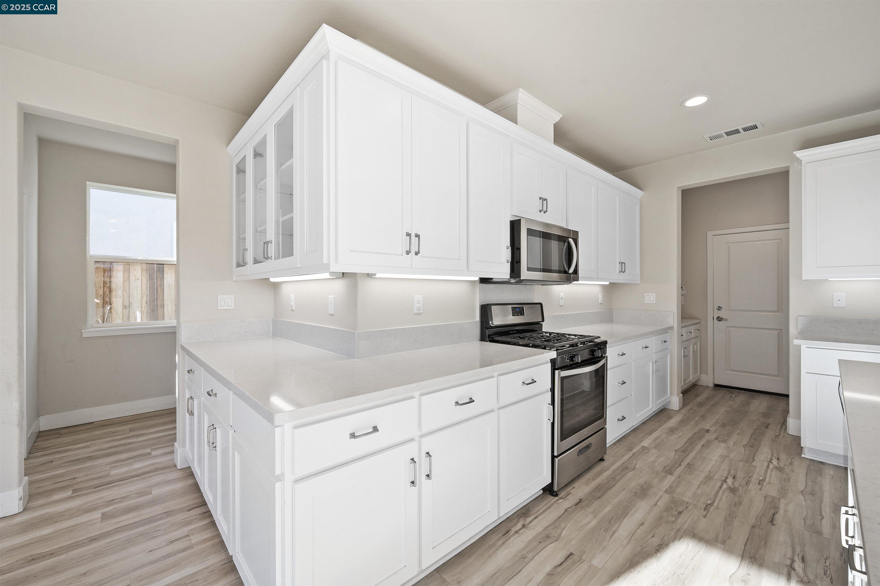 5541 Promontory Way Antioch, CA 94531 - Photo 44 of 59 a kitchen with a stove a sink and a refrigerator