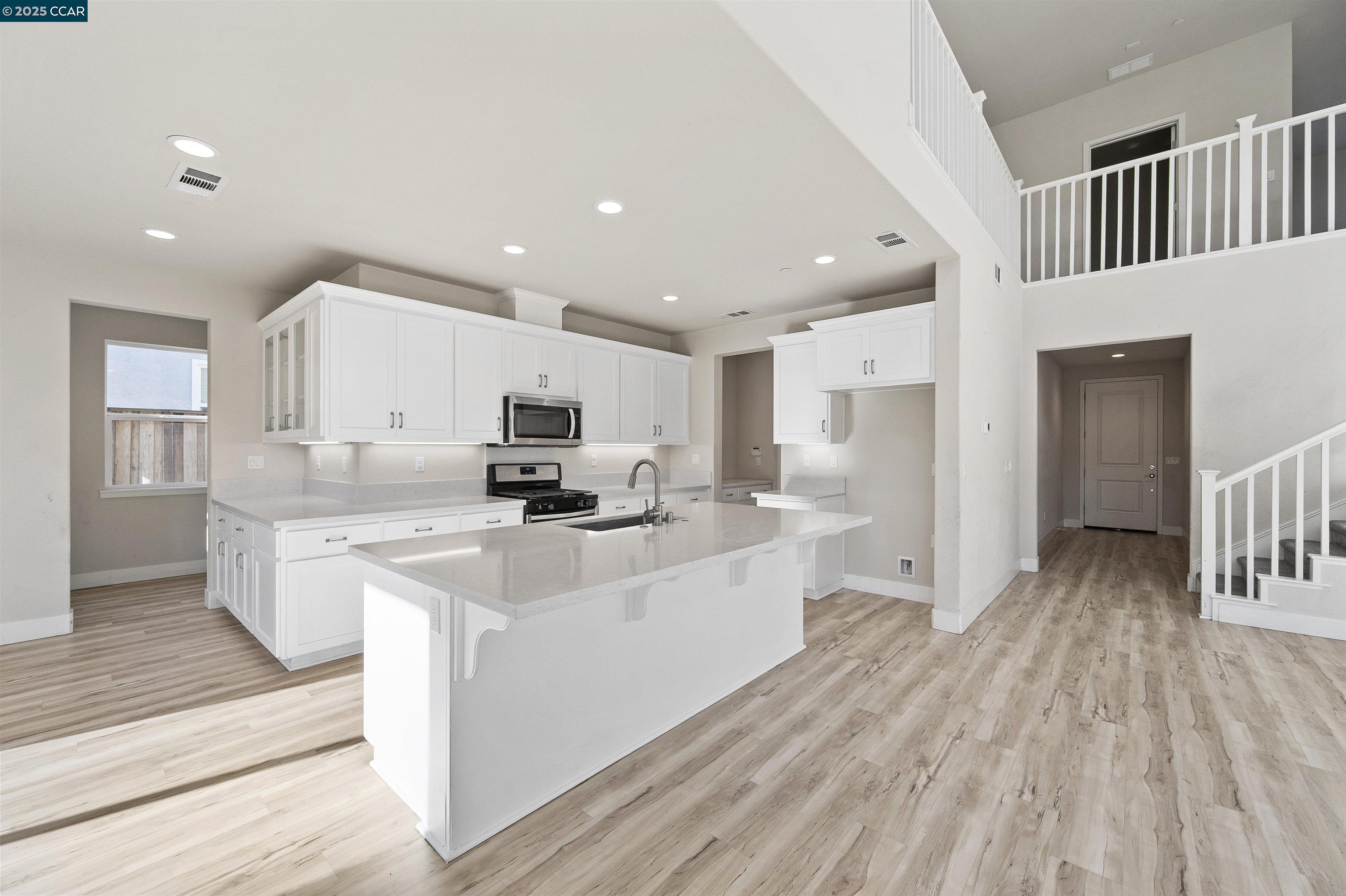 5541 Promontory Way Antioch, CA 94531 - Photo 49 of 59 a large white kitchen with stainless steel appliances