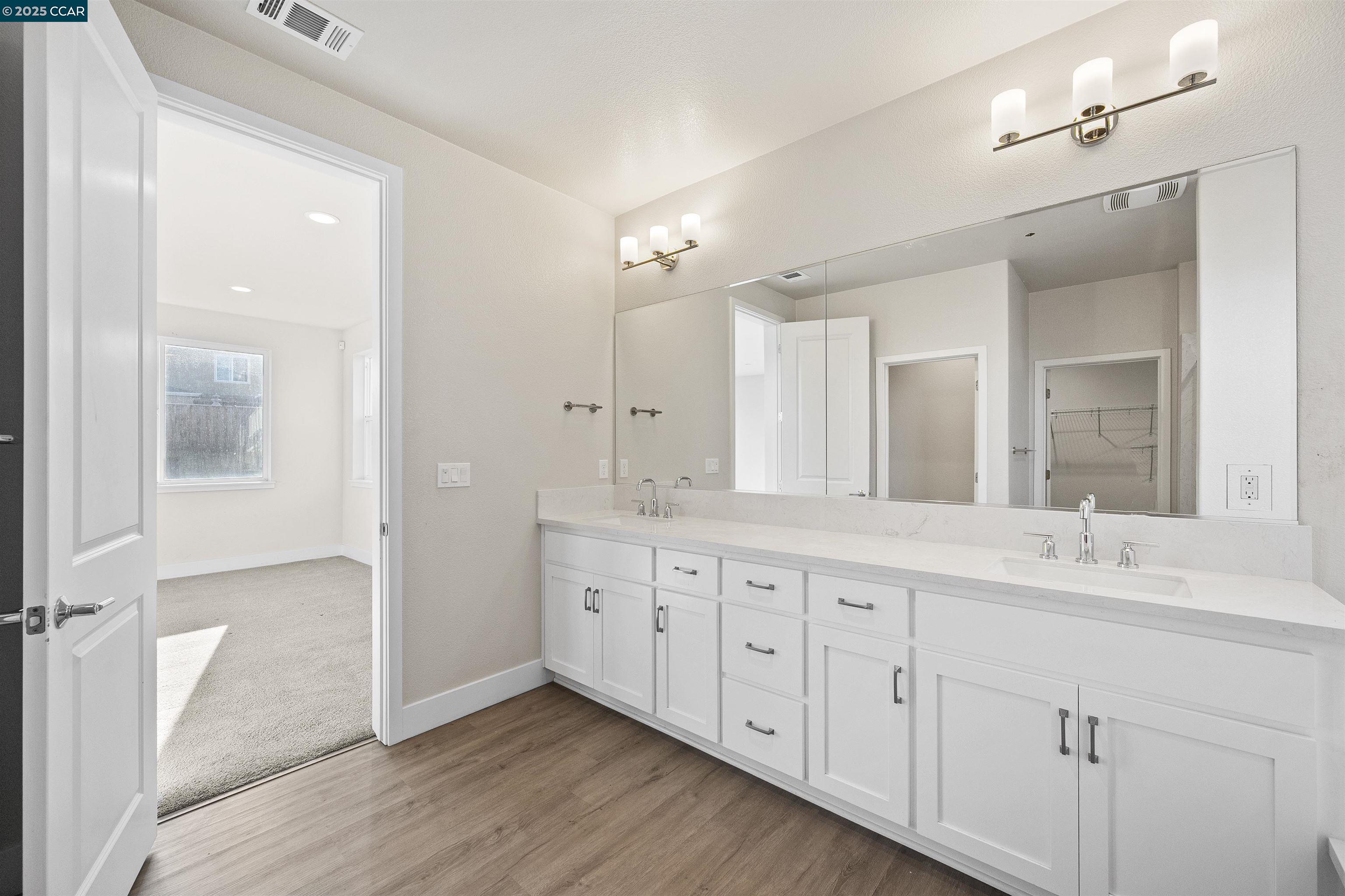5541 Promontory Way Antioch, CA 94531 - Photo 5 of 59 a spacious bathroom with a double vanity sink a mirror and a shower