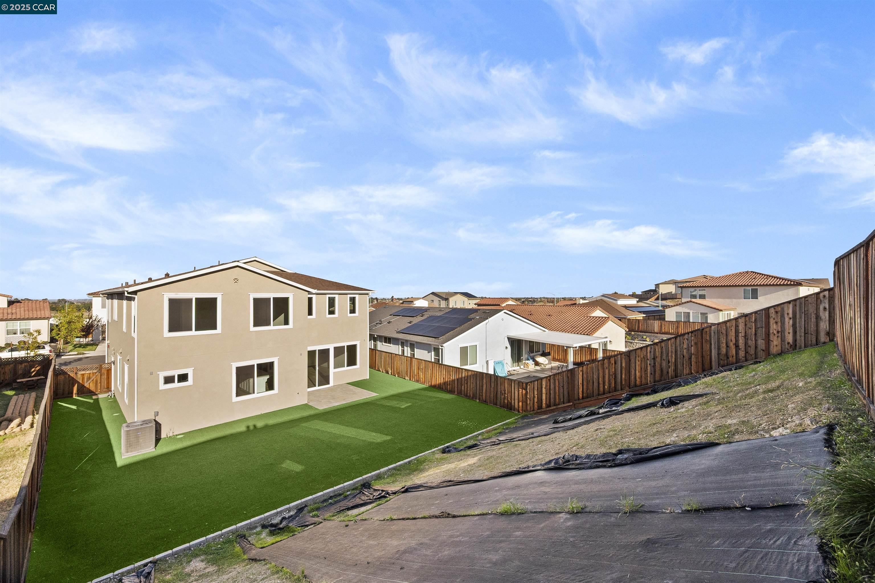 5541 Promontory Way Antioch, CA 94531 - Photo 10 of 59 a view of a white house with a big yard and large trees