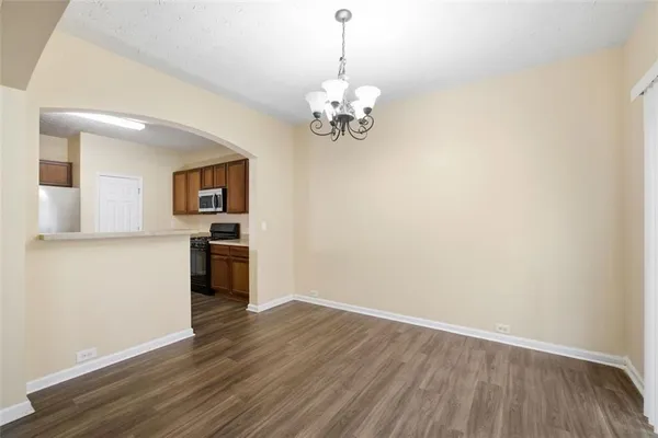 a view of a room with wooden floor and a ceiling fan
