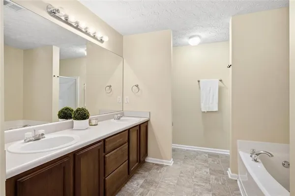 a bathroom with a double vanity sink and a mirror