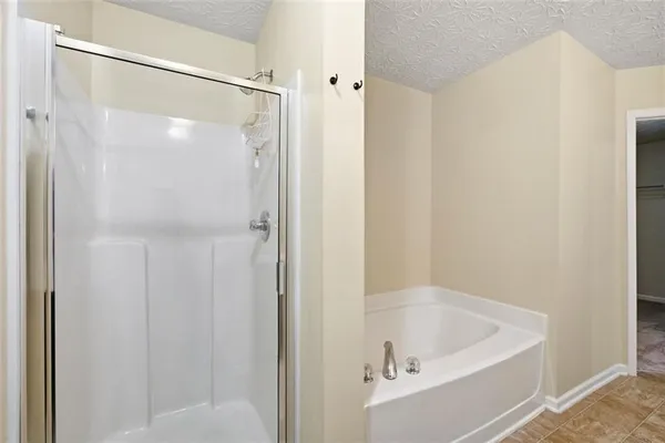 a bathroom with a tub and shower
