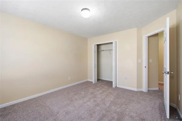 an empty room with closet area