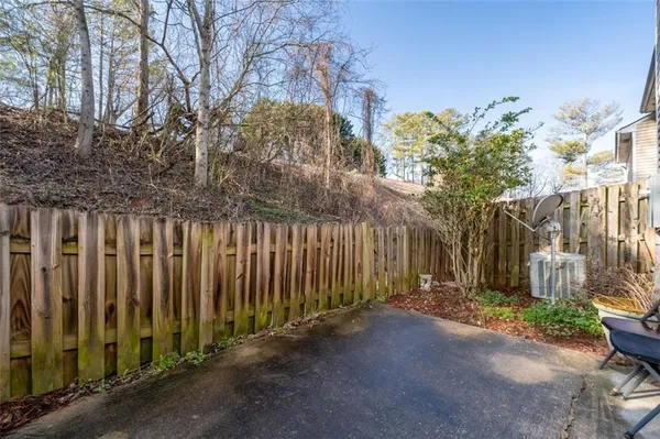 a view of a pathway with a wrought fence