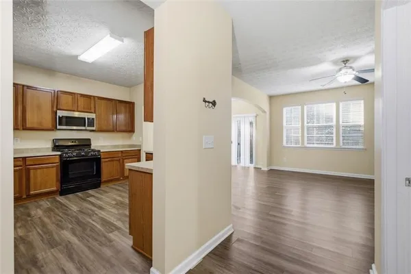 a kitchen with stainless steel appliances granite countertop a refrigerator stove and sink
