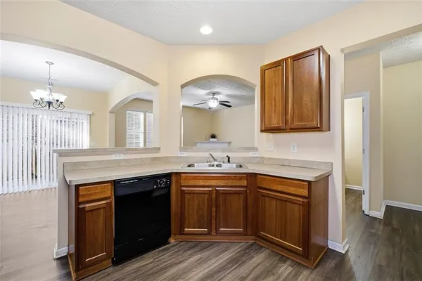 a kitchen with a sink stove and cabinets
