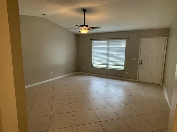 a view of a livingroom with a ceiling fan and window