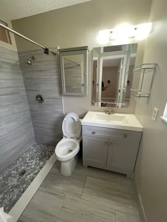 a bathroom with a sink toilet and shower