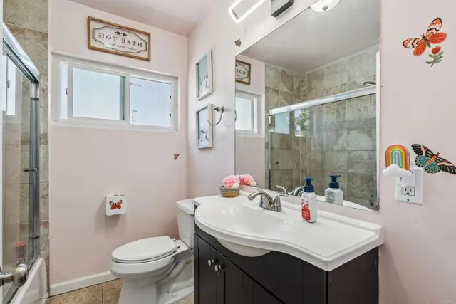 a bathroom with a sink mirror vanity and toilet