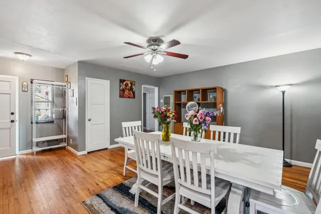 a view of a dining room with furniture wooden floor and chandelier
