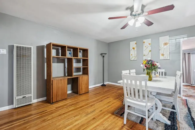 a dining room with furniture entryway and wooden floor