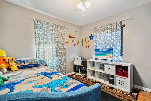 a bed sitting in a bedroom next to a window