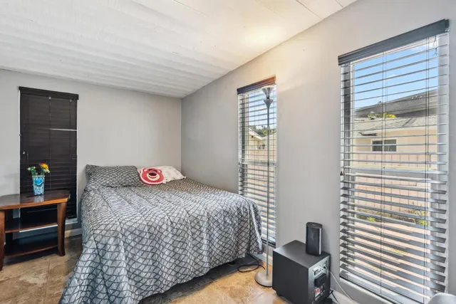 a bedroom with bed and a window