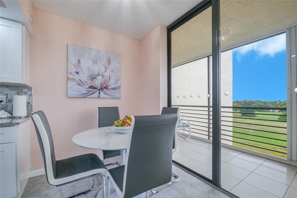 7300 Radice Court, Unit 404 Lauderhill, FL 33319 - Photo 15 of 85 a view of a dining room with furniture window and wooden floor