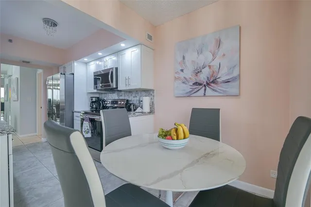 a large bed sitting in a bedroom next to a lamp