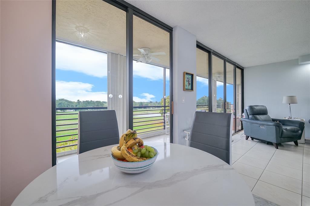 7300 Radice Court, Unit 404 Lauderhill, FL 33319 - Photo 17 of 85 a living room with furniture and a potted plant