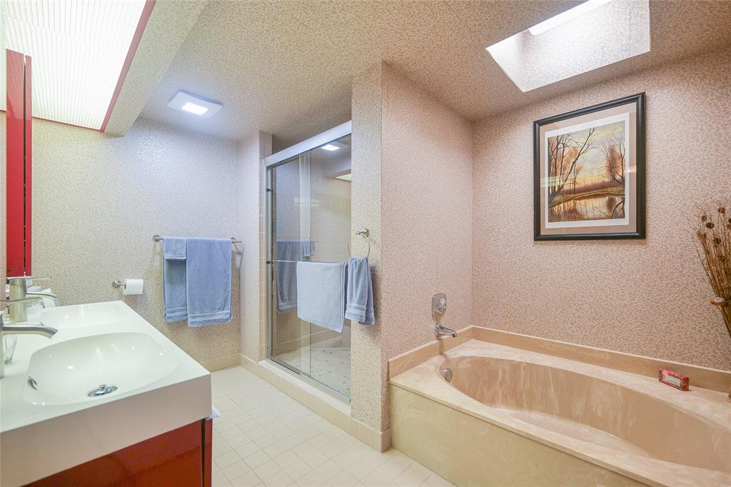 7300 Radice Court, Unit 404 Lauderhill, FL 33319 - Photo 25 of 85 a bathroom with a tub a sink and mirror