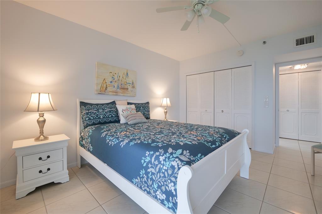 7300 Radice Court, Unit 404 Lauderhill, FL 33319 - Photo 31 of 85 a bedroom with a bed and a chandelier