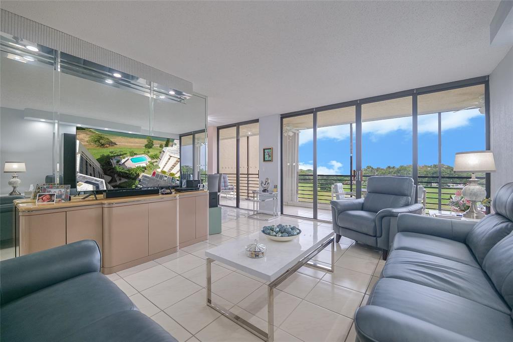 7300 Radice Court, Unit 404 Lauderhill, FL 33319 - Photo 4 of 85 a living room with furniture and a large window