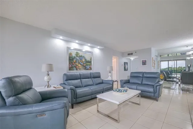 a kitchen with stainless steel appliances granite countertop a stove a refrigerator and a microwave