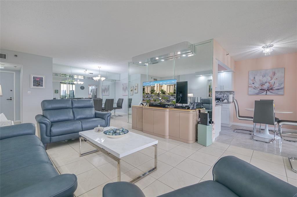 7300 Radice Court, Unit 404 Lauderhill, FL 33319 - Photo 6 of 85 a living room with furniture and a view of kitchen