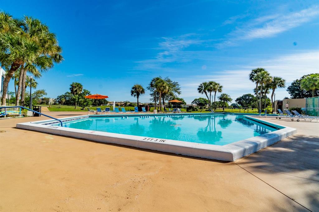 7300 Radice Court, Unit 404 Lauderhill, FL 33319 - Photo 62 of 85 a view of a swimming pool and a yard