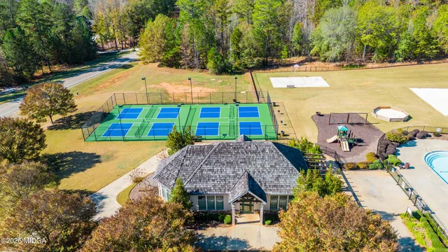 an aerial view of a house with a yard