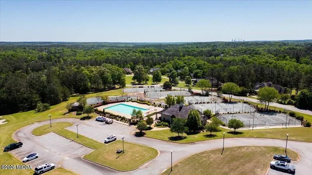 a view of a house with a big yard and potted plants