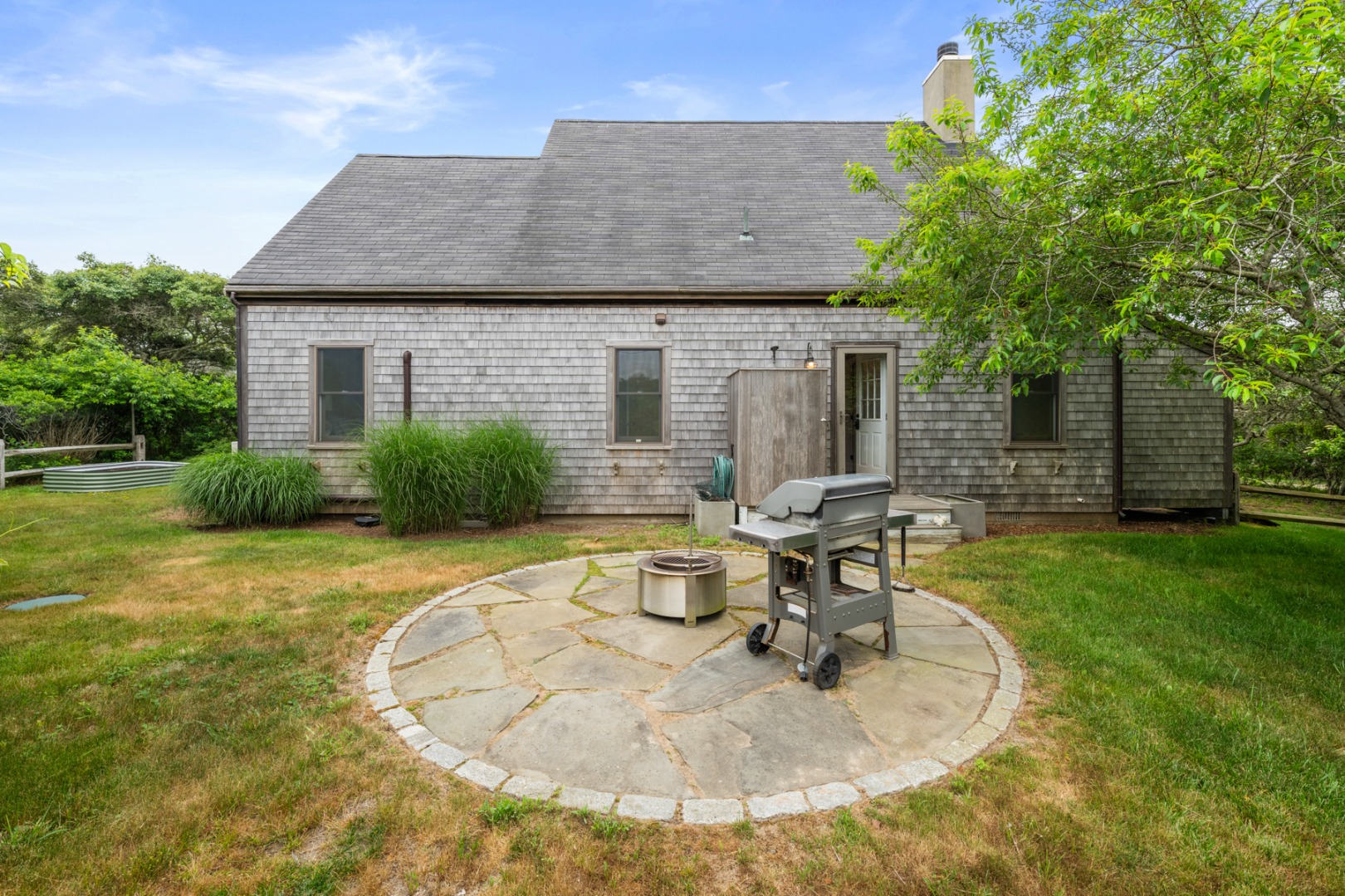 4 Berkley Street Nantucket, MA 02554 - Photo 46 of 47 a backyard of a house with table and chairs