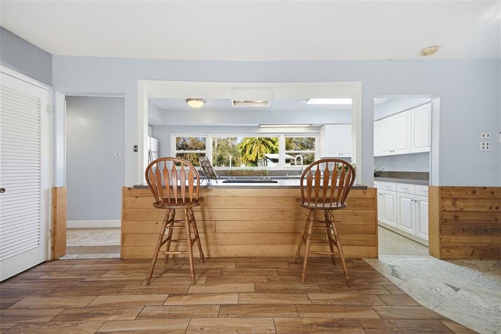 9214 Rhea Drive Odessa, FL 33556 - Photo 16 of 67 a view of a dining room with furniture and wooden floor