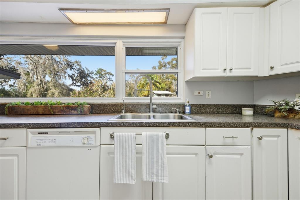 9214 Rhea Drive Odessa, FL 33556 - Photo 18 of 67 a kitchen with granite countertop white cabinets and window