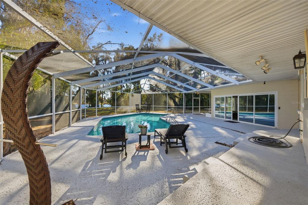9214 Rhea Drive Odessa, FL 33556 - Photo 26 of 67 a view of a patio with table and chairs with wooden floor and fence