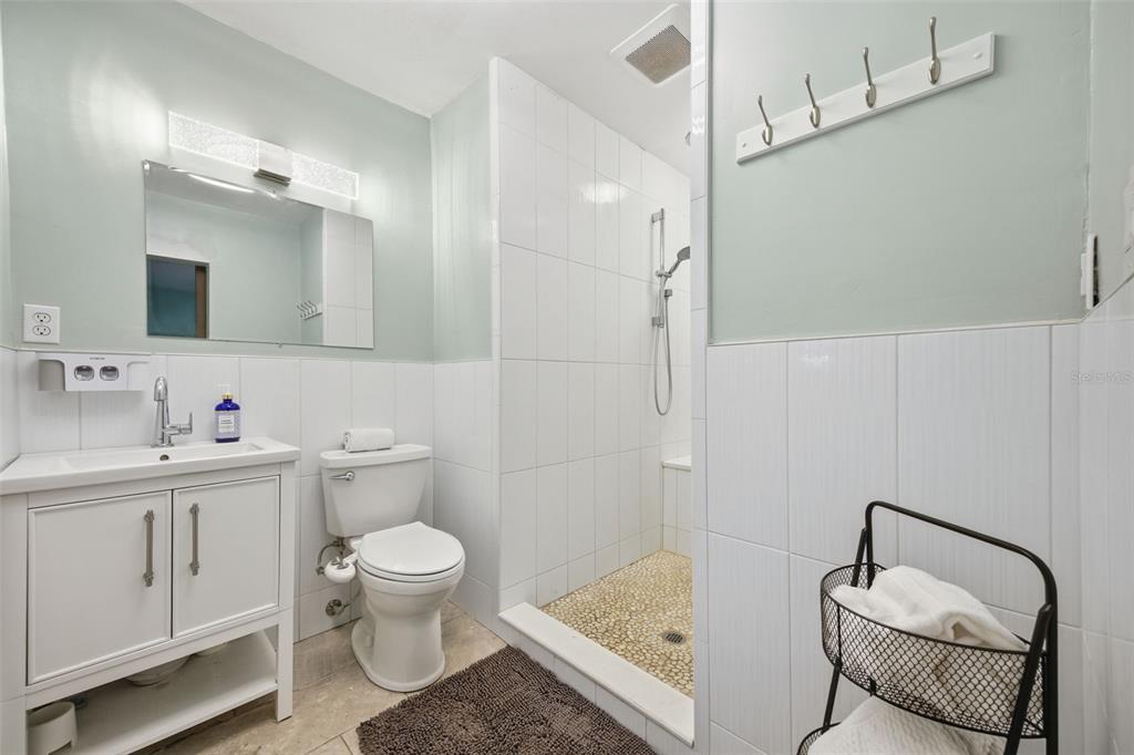 9214 Rhea Drive Odessa, FL 33556 - Photo 33 of 67 a bathroom with a granite countertop sink a toilet and a mirror