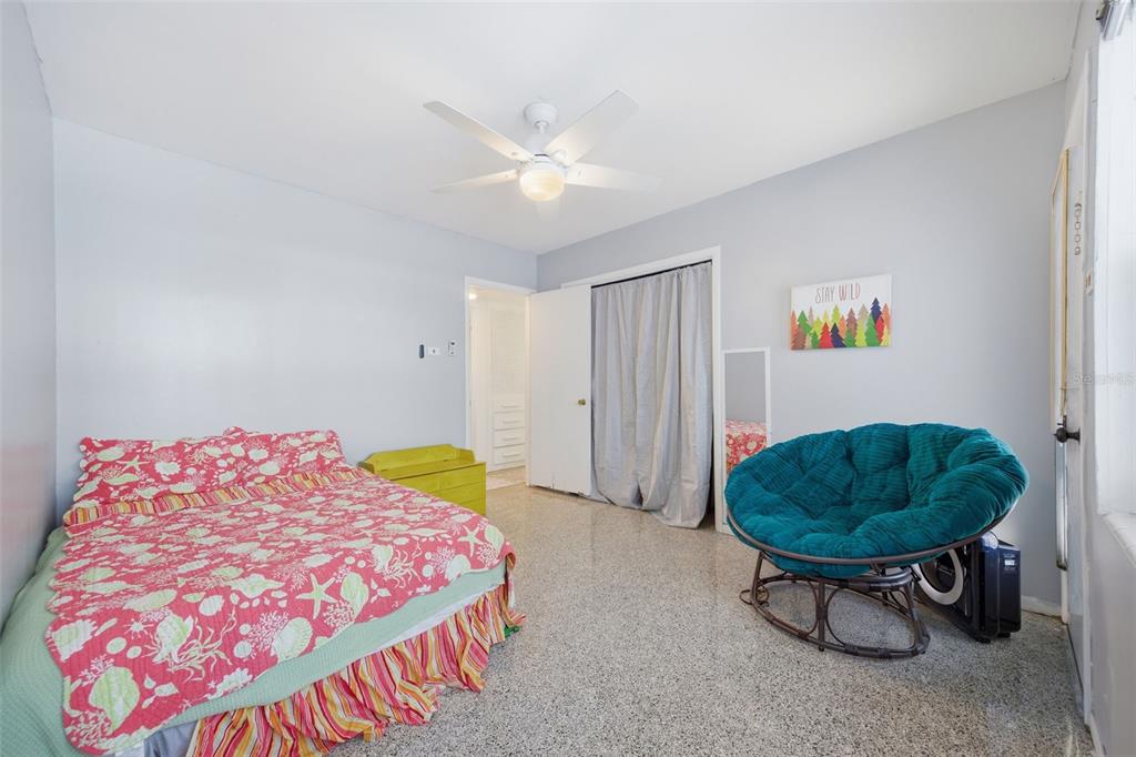 9214 Rhea Drive Odessa, FL 33556 - Photo 41 of 67 a bedroom with a bed and a chandelier