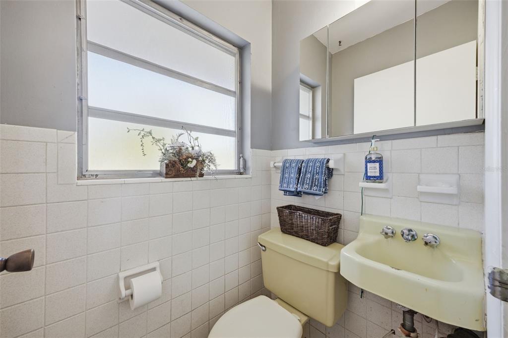 9214 Rhea Drive Odessa, FL 33556 - Photo 42 of 67 a bathroom with a toilet sink and mirror