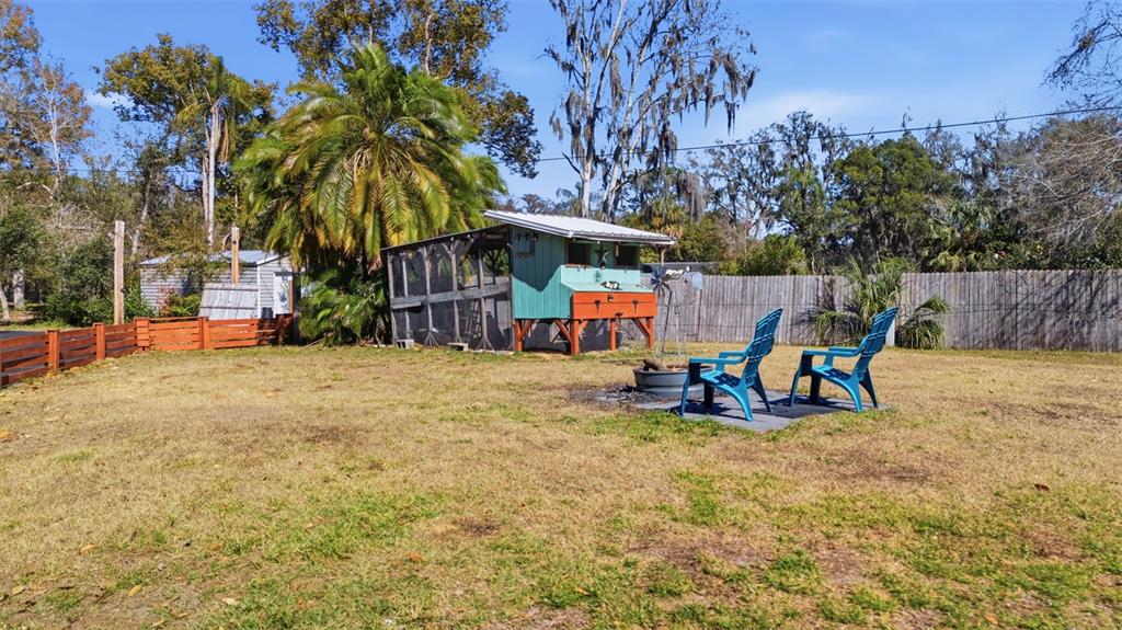 9214 Rhea Drive Odessa, FL 33556 - Photo 53 of 67 a view of backyard with a table and chairs under an umbrella