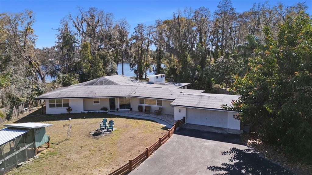 9214 Rhea Drive Odessa, FL 33556 - Photo 57 of 67 an aerial view of a house with swimming pool and large trees