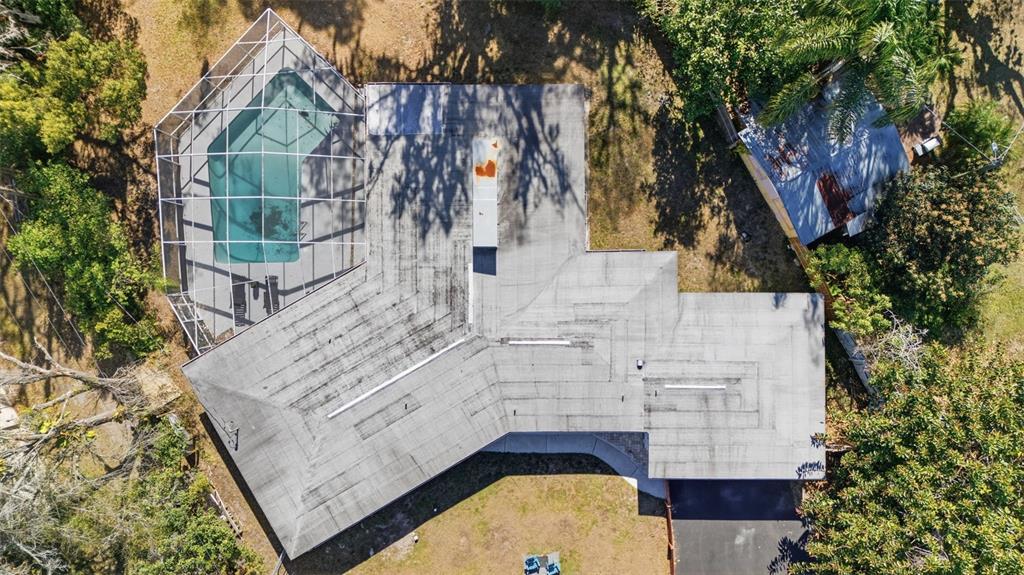 9214 Rhea Drive Odessa, FL 33556 - Photo 61 of 67 an aerial view of a house with swimming pool and large trees