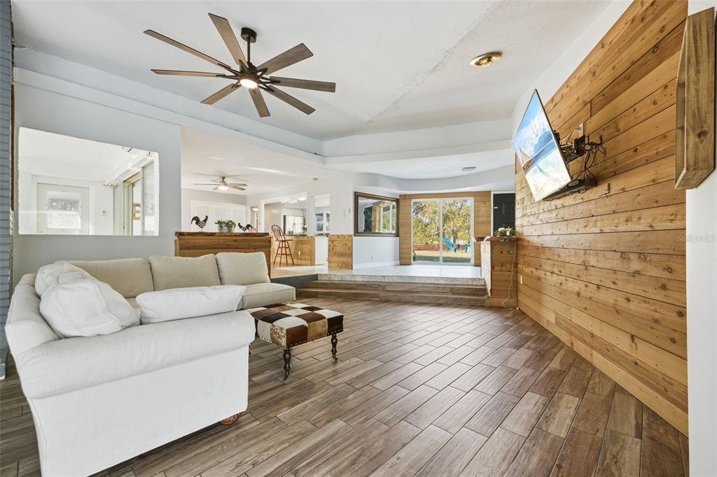 9214 Rhea Drive Odessa, FL 33556 - Photo 9 of 67 a living room with couches and a fireplace with wooden floor