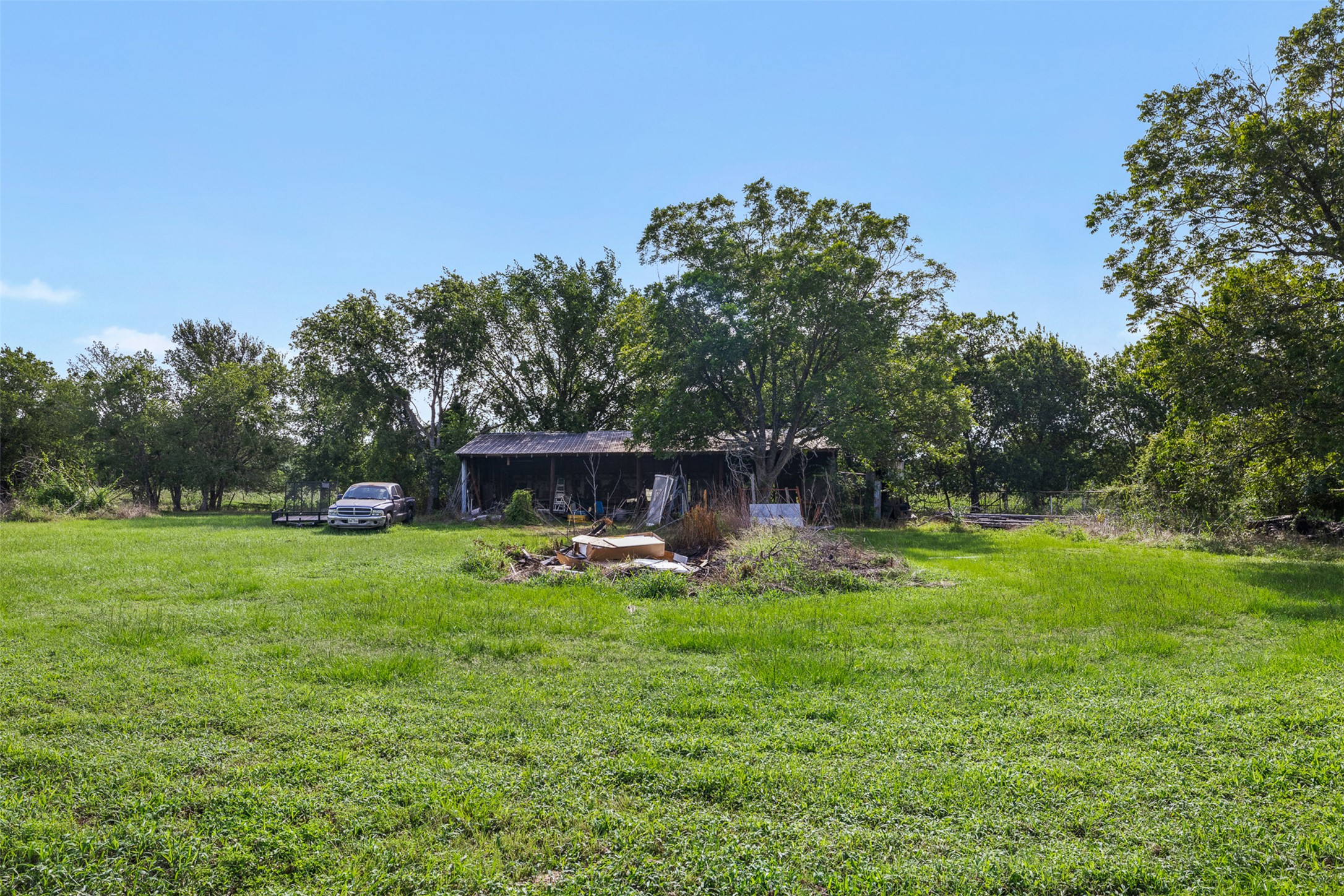 1015 FM 112 Road Lexington, TX 78947 - Photo 26 of 38 a backyard of a house with table and chairs