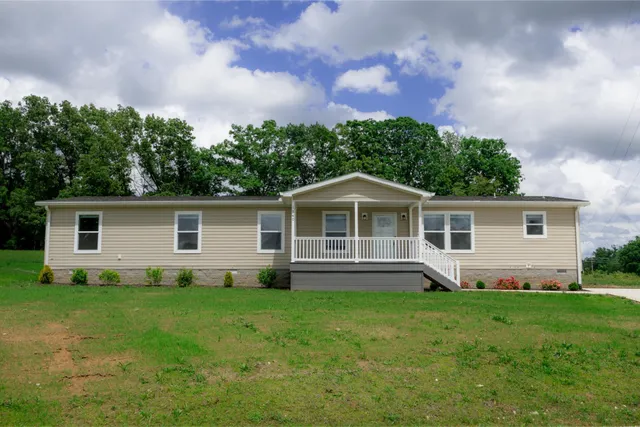 a front view of house with yard and green space