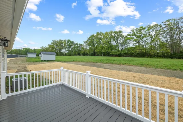 a view of a yard with wooden fence